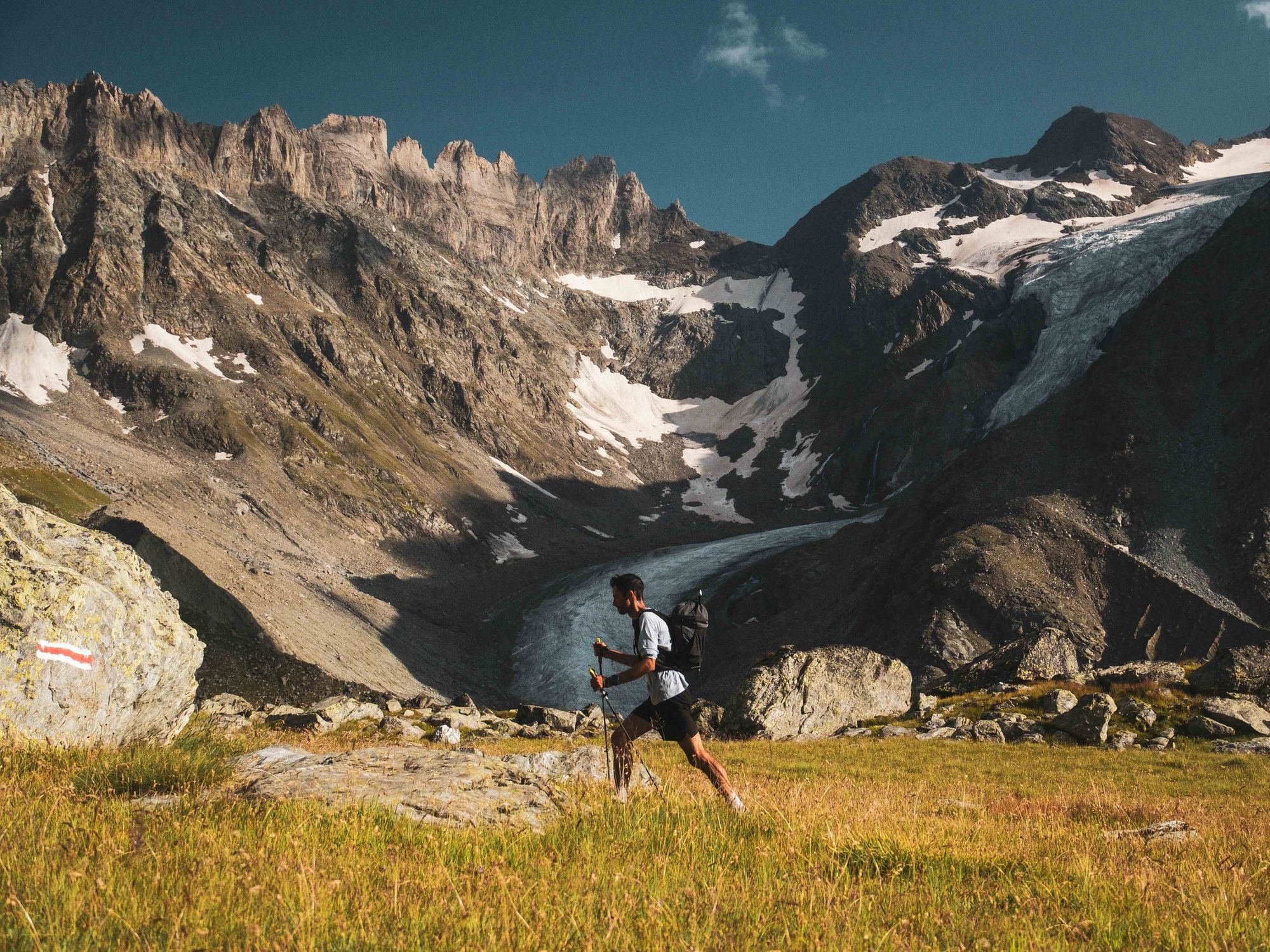 Photo of Kilian Jornet walking in the Alps.