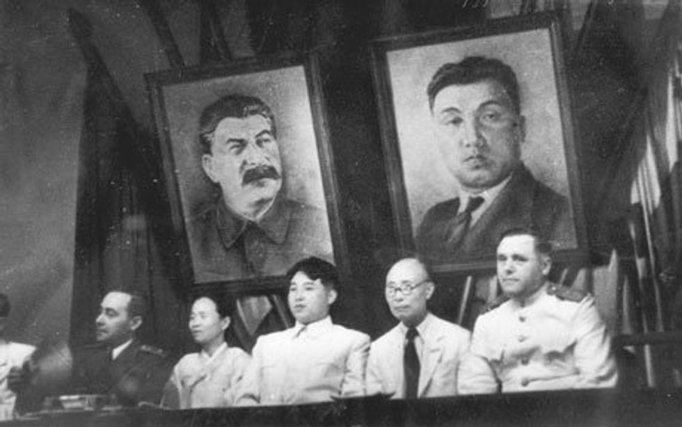 photo of Kim Il Sung and other communist leaders with pictures of Stalin and Kim behind