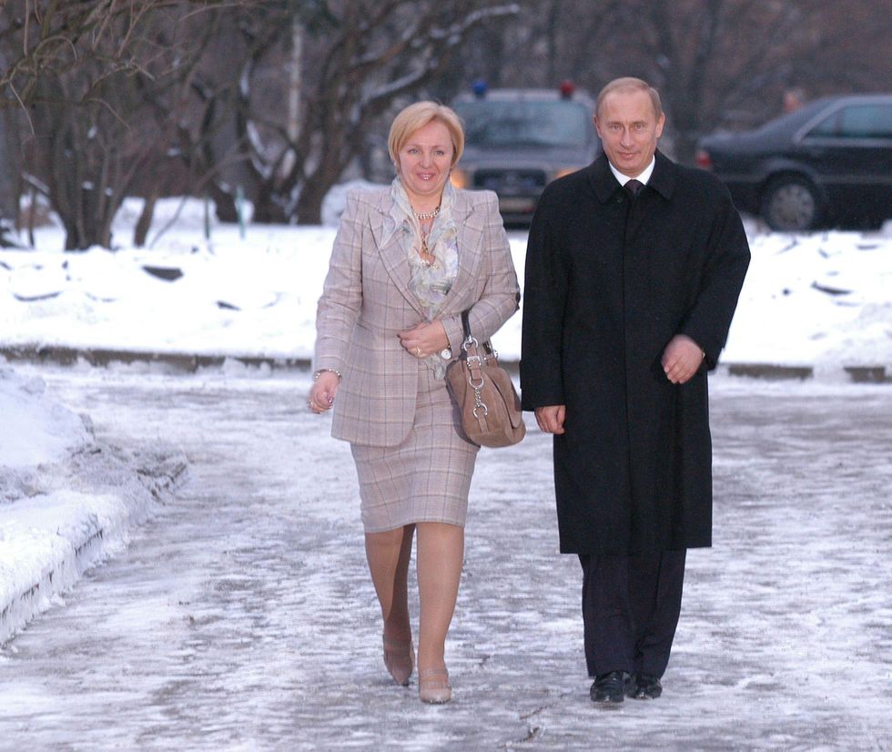 Photo of Lyudmila Putina and Vladimir Putin walking in the snow