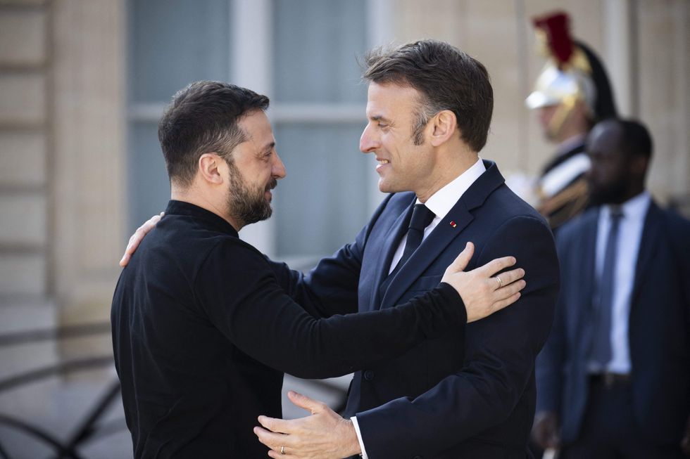 Photo of Macron and Zelensky embracing at the Elysee Palace on March 27, 2025