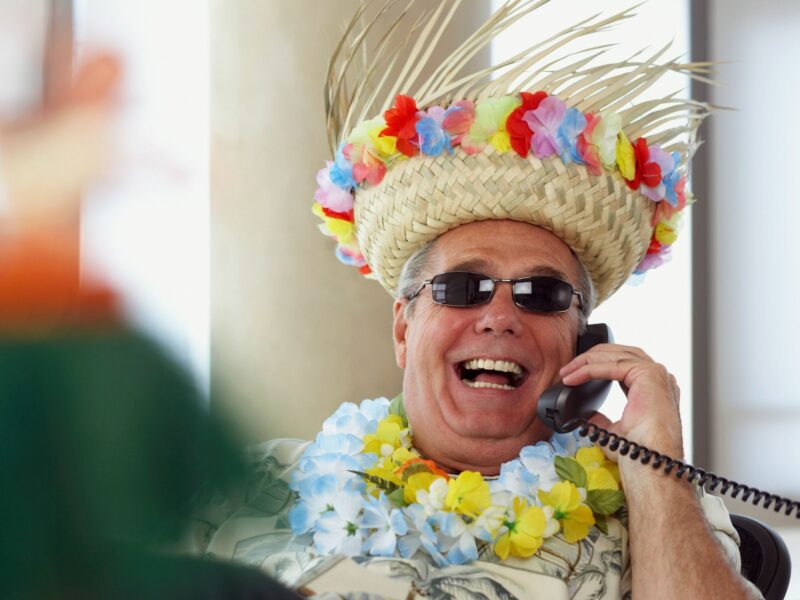 Photo of man in vacation hat in the office