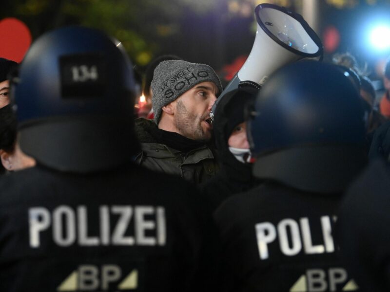 photo of man speaking in megaphone at protest in Saxony