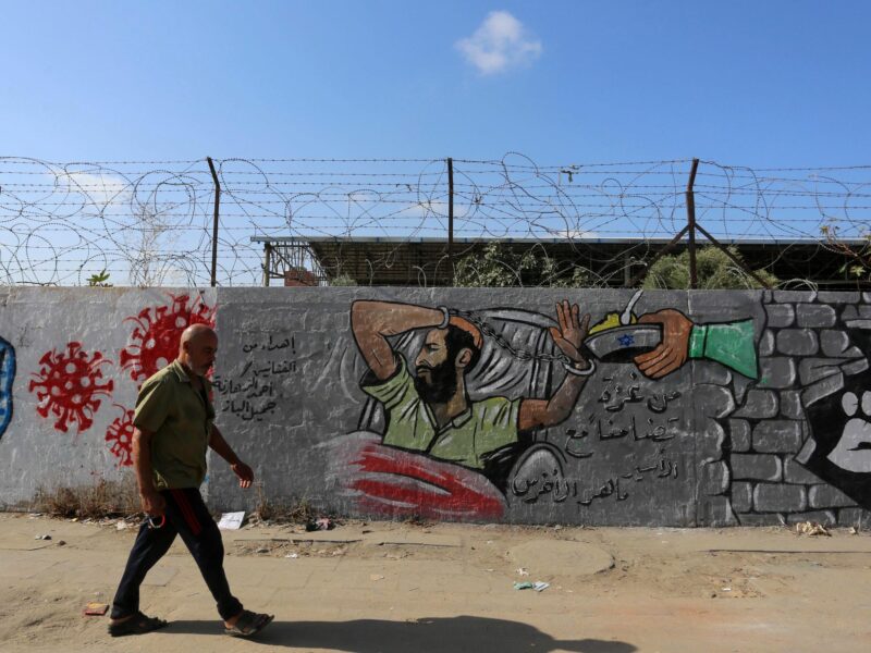 Photo of man walking past a prison in Israel