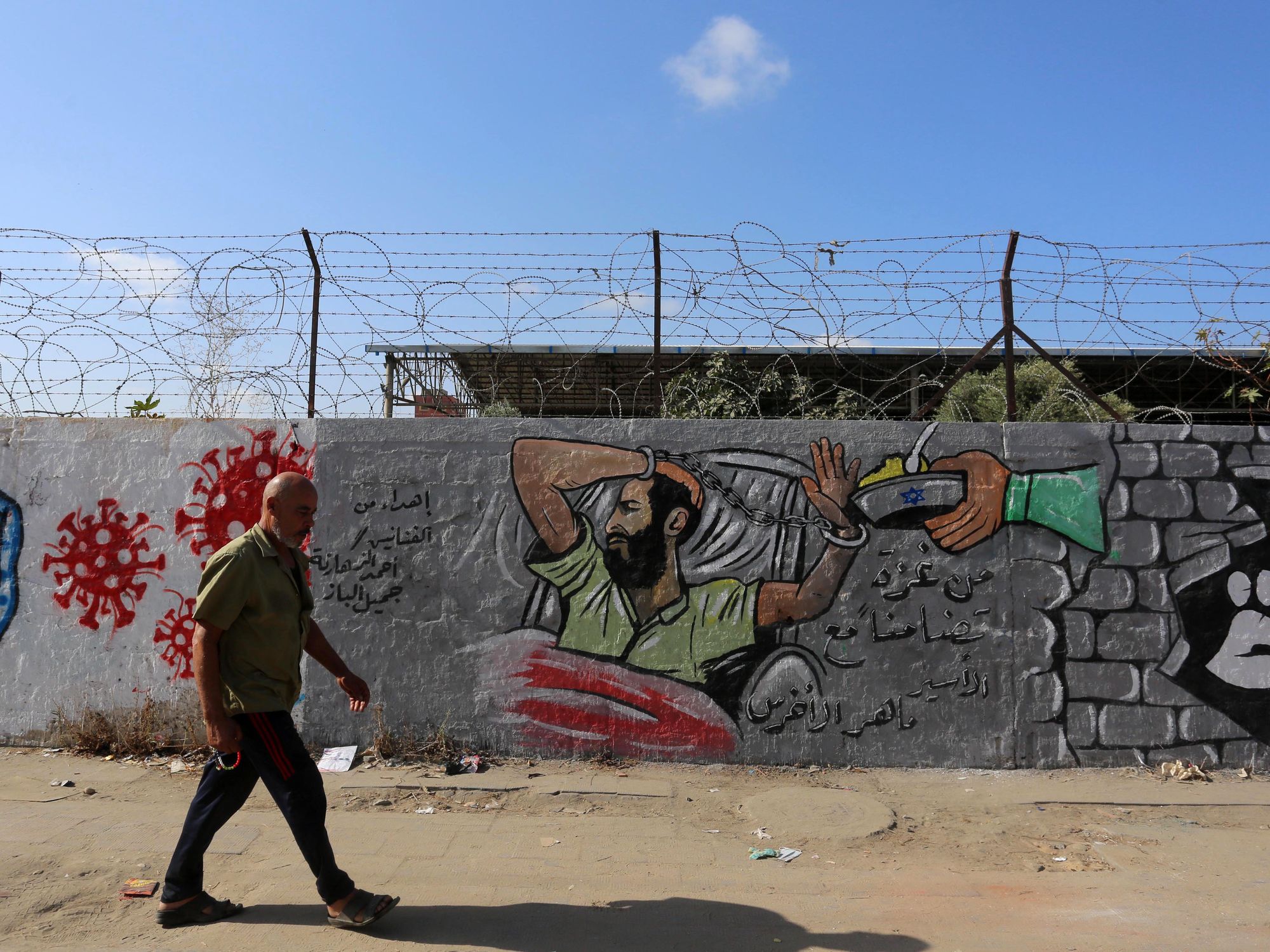 Photo of man walking past a prison in Israel
