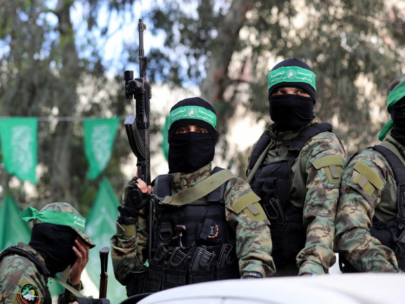 photo of masked men with weapons