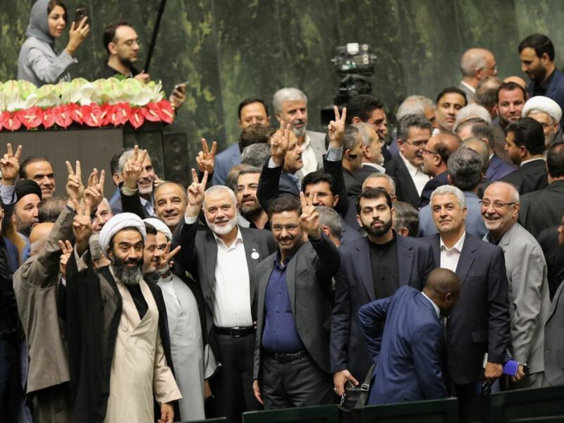 photo of men holding up victory sign