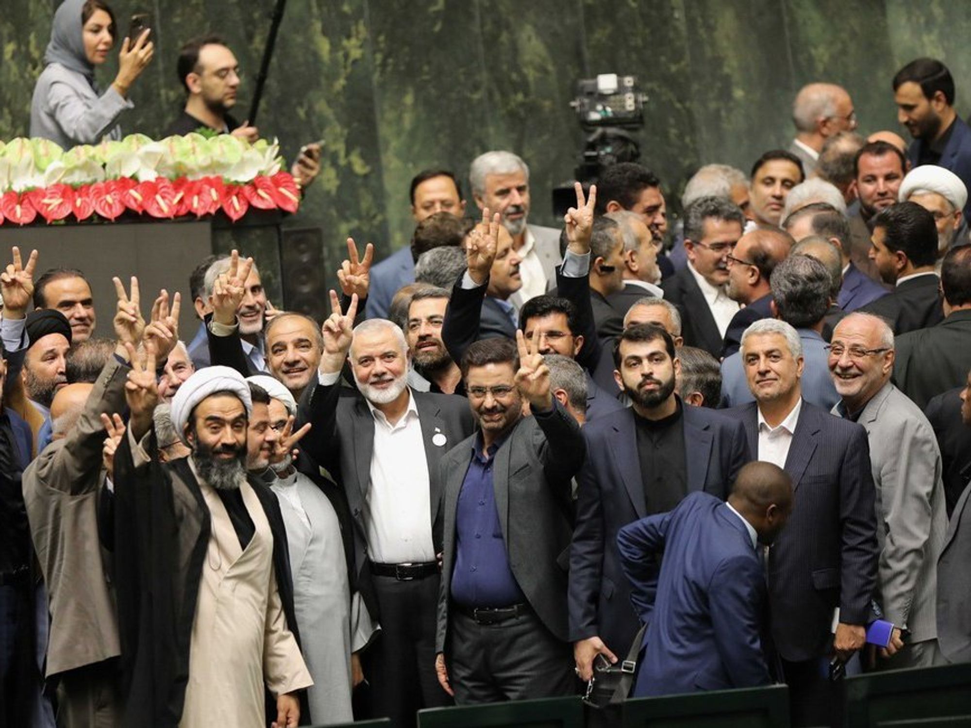 photo of men holding up victory sign