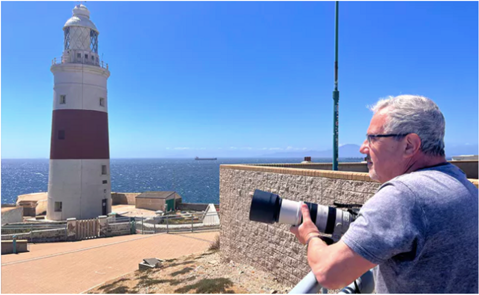 photo of michael sanchez holding his long lens camera