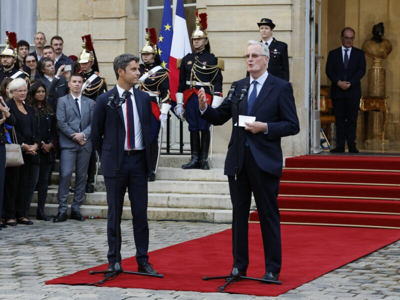 photo of Michel Barnier speaking at the Elysee with Gabriel Attal listening.