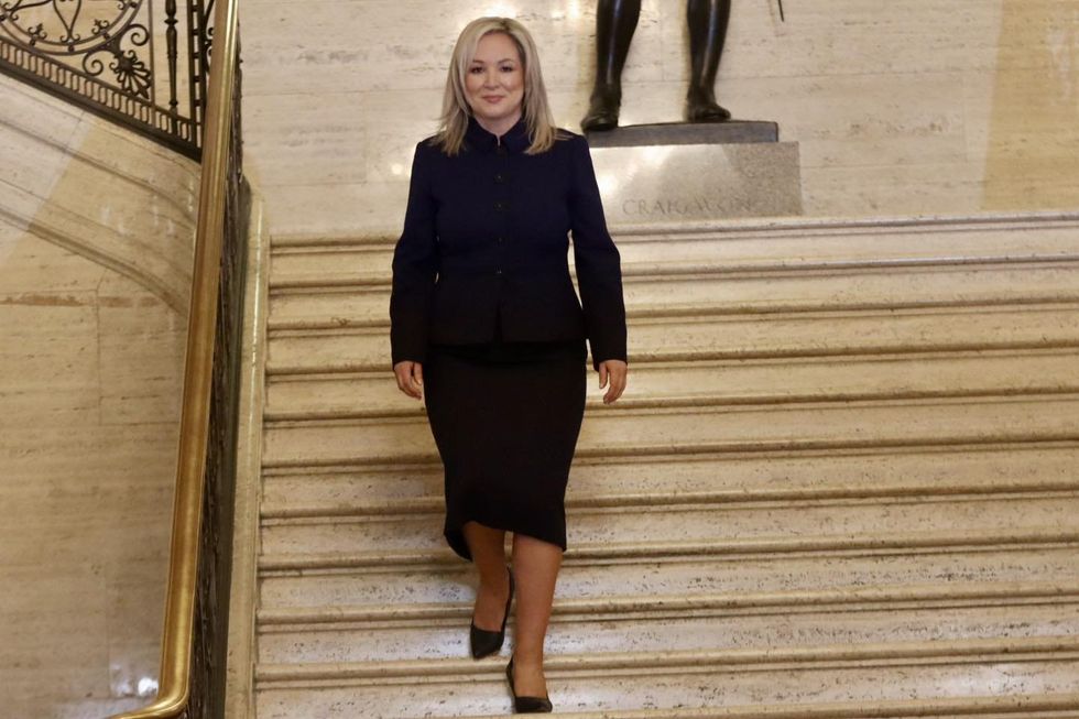 photo of michelle o'neill walking down stairs