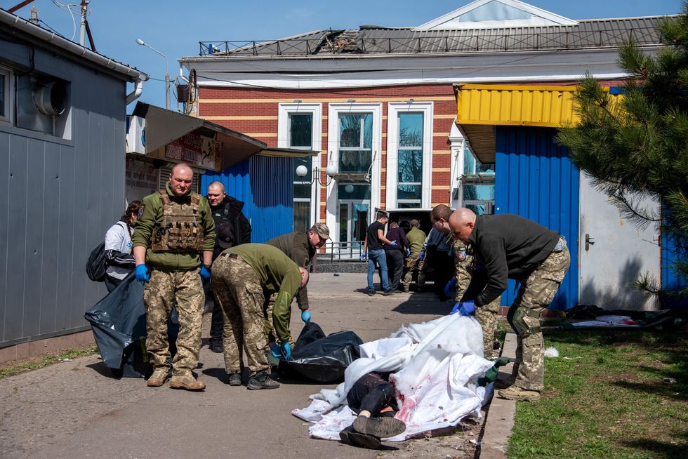 photo of military covering dead bodies at Kramatorsk railway station