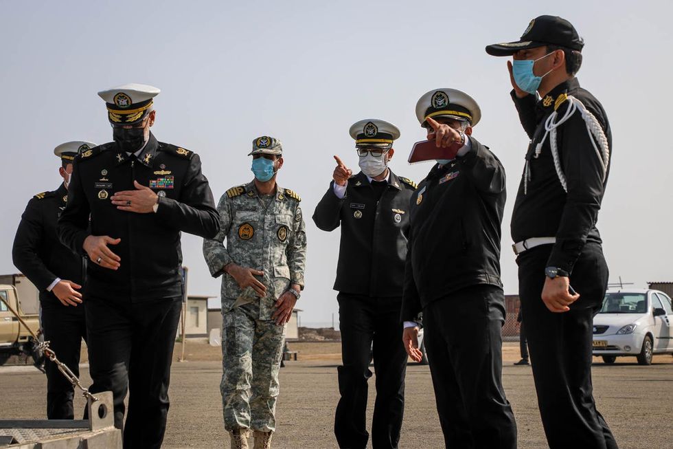 photo of military men in uniform on a tarmac