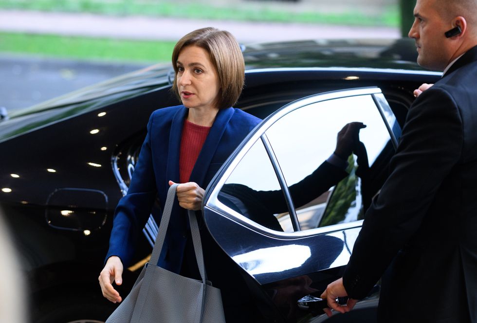 Photo of Moldovan President Maia Sandu stepping out of her car.