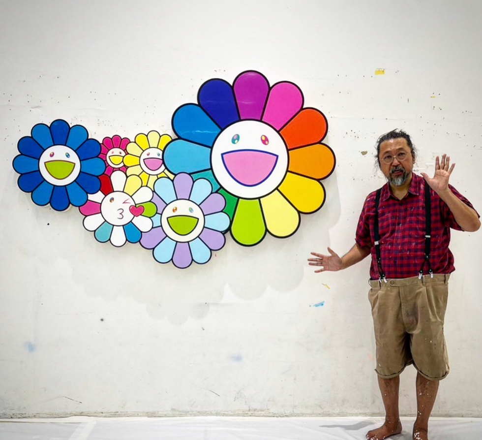 Photo of Murakami at the Bourget in the suburbs of Paris, France with one of his artworks