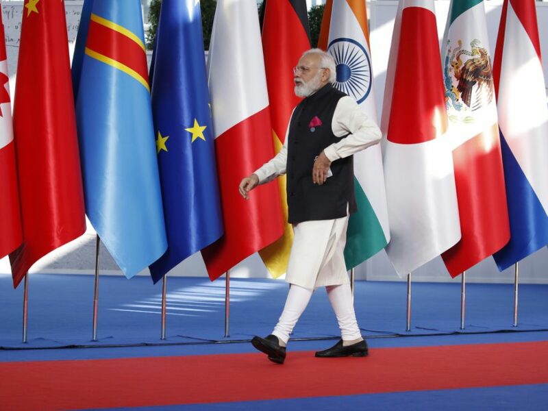 Photo of Narendra Modi walking past flags