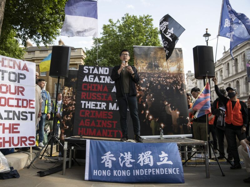 Photo of Nathan Law, an activist in exile and former member of the Legislative Council in Hong Kong speaks during a rally.