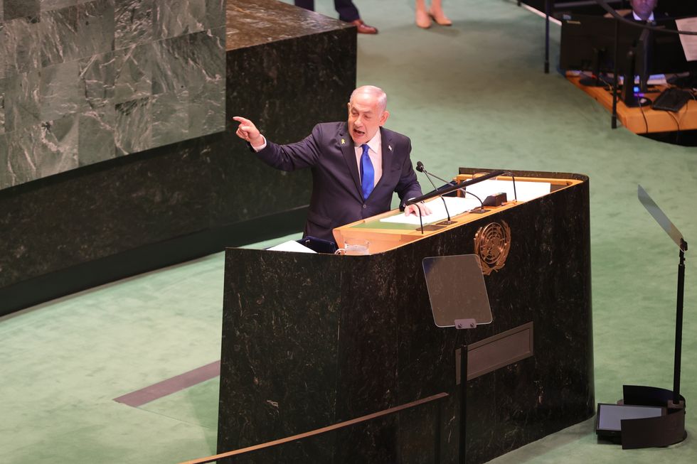 photo of Netanyahu speaking and pointing from podium