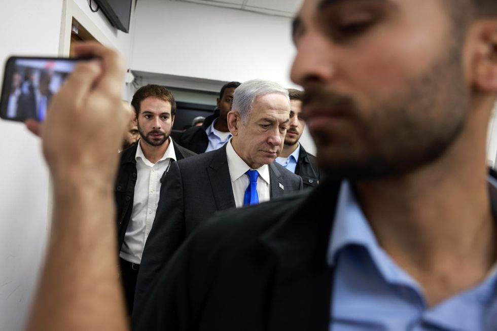photo of Netanyahu walking with aides around him