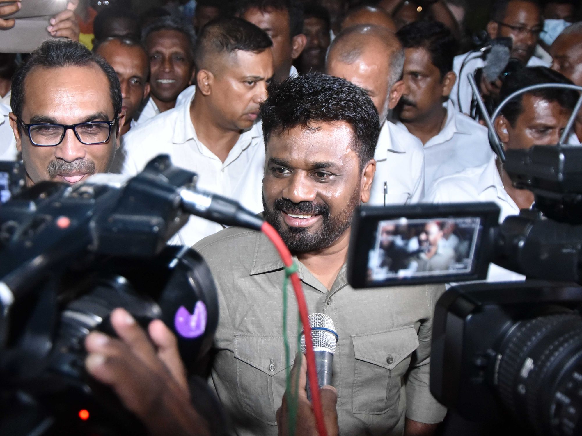 Photo of New Sri Lankan leader Anura Kumara Dissanayake speaking to TV cameras