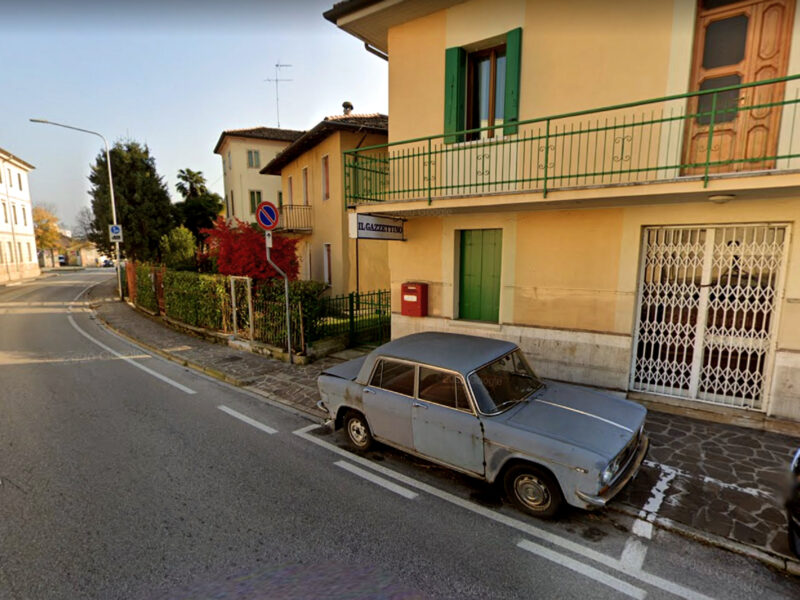 photo of old car in front of the building