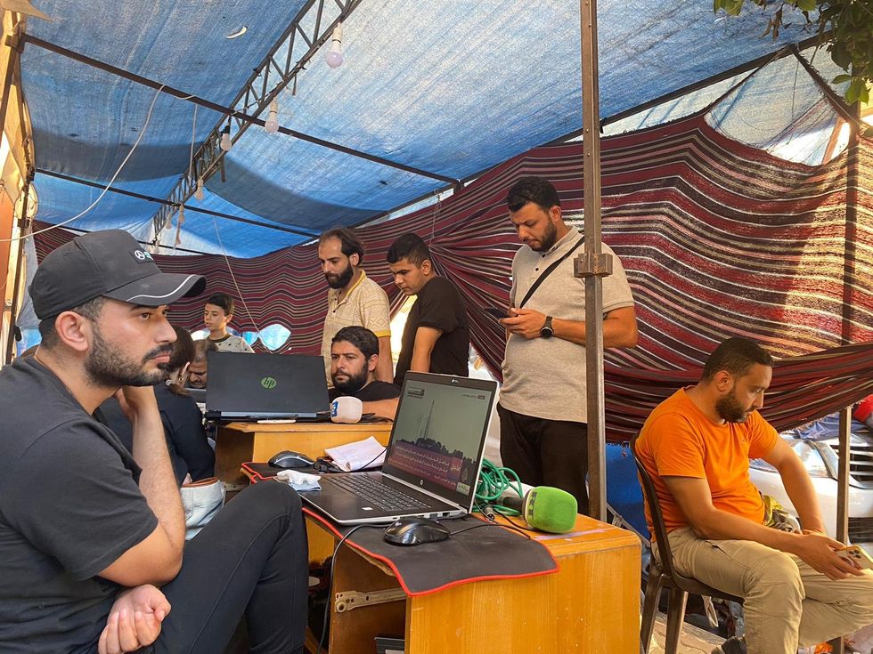 Photo of Palestinian journalists in a tent working