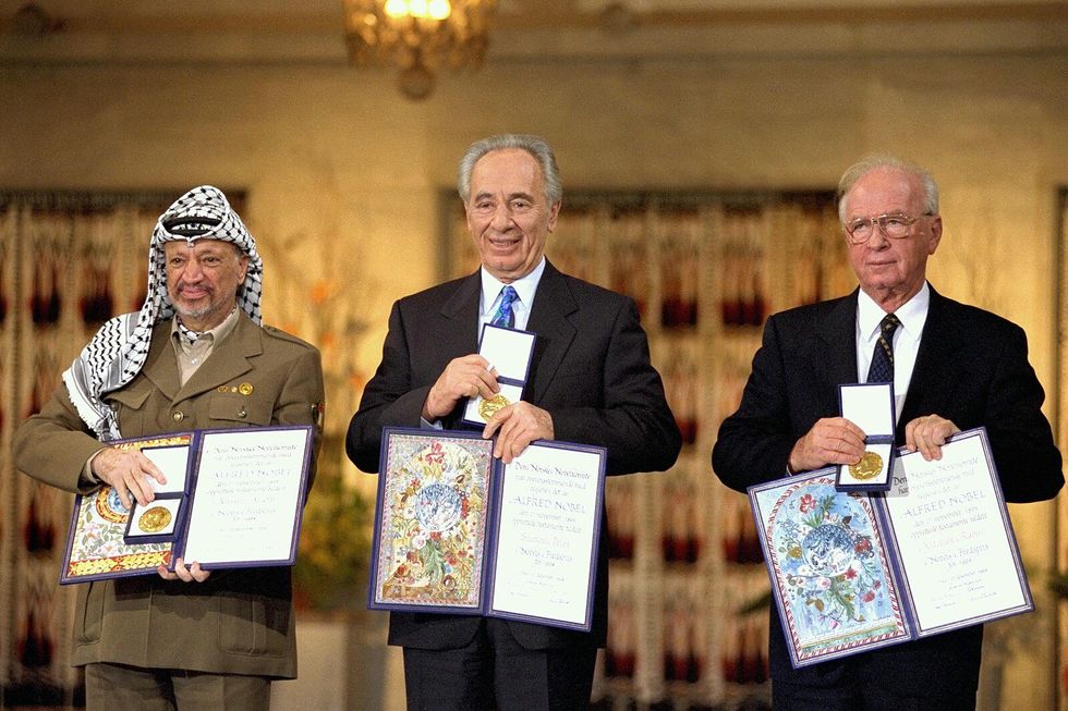 Photo of Palestinian leader ​Yasser Arafat, Israeli Foreign Minister Shimon Peres, Israeli Prime Minister Yitzhak Rabin being awarded a joint Nobel peace prize in Oslo on Dec. 10, 1994.