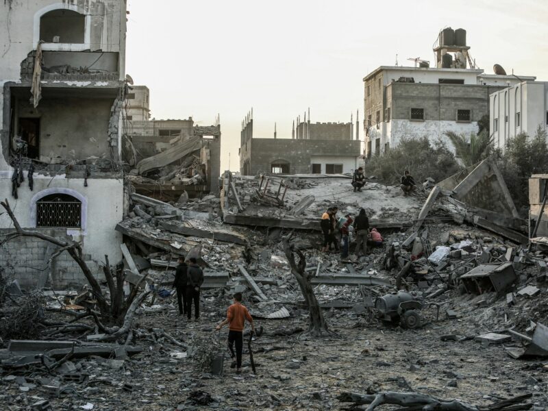 Photo of Palestinians among rubble in Gaza
