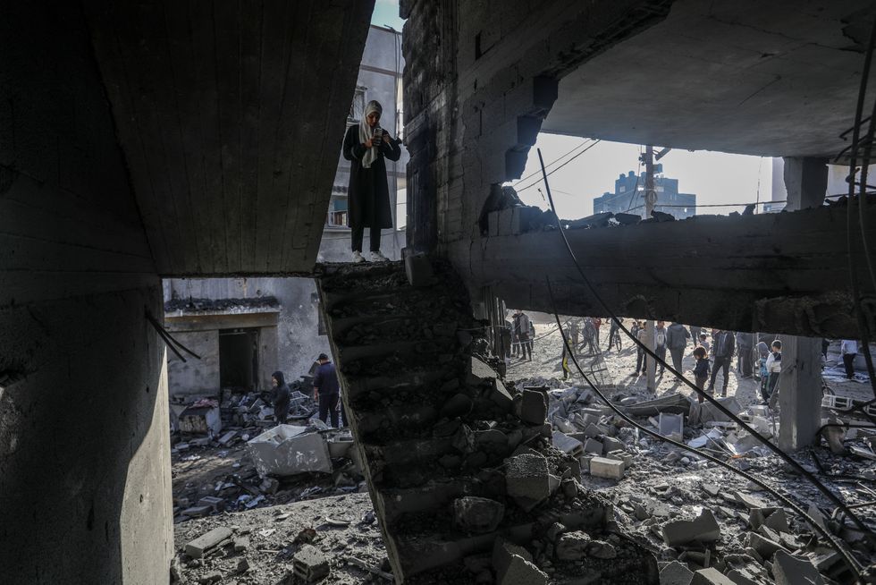 Photo of Palestinians among the rubble in Rafah, Gaza