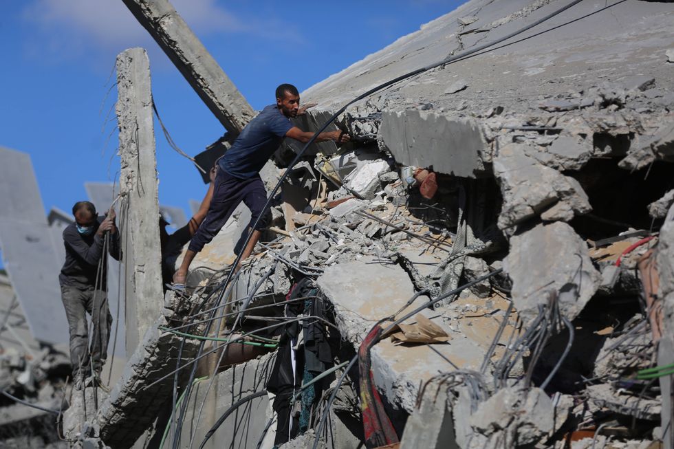 Photo of Palestinians checking destroyed buildings in a refugee camp in central Gaza on Sept. 18, 2024.
