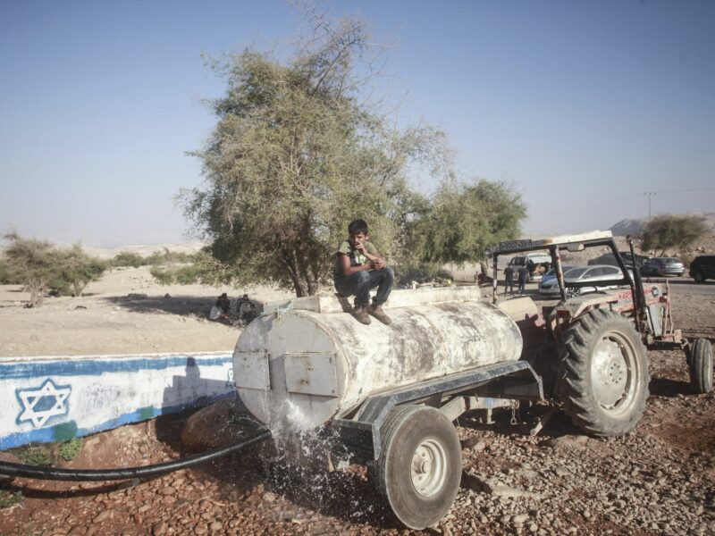 Photo of Palestinians filling up their tanks with water