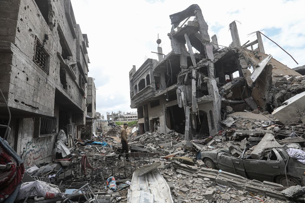 Photo of Palestinians inspecting the rubble after an Israeli air strike on Beit Lahia, northern Gaza, March 20.