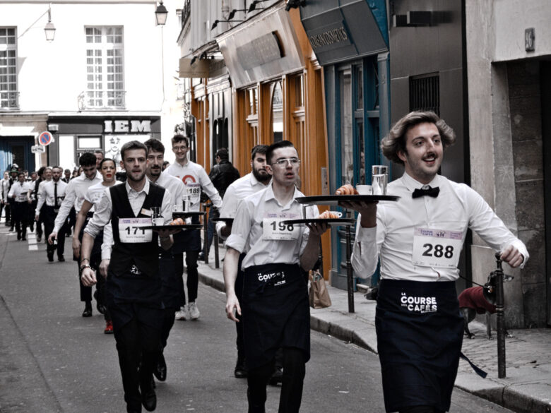 Photo of Parisian waiters participating in the 2024 "Course des Cafés" race