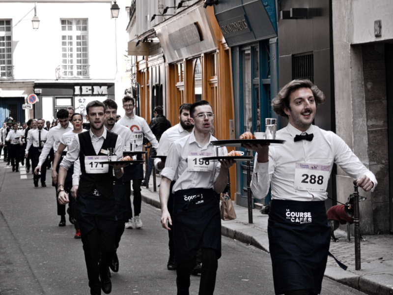 Photo of Parisian waiters participating in the 2024 "Course des Cafés" race
