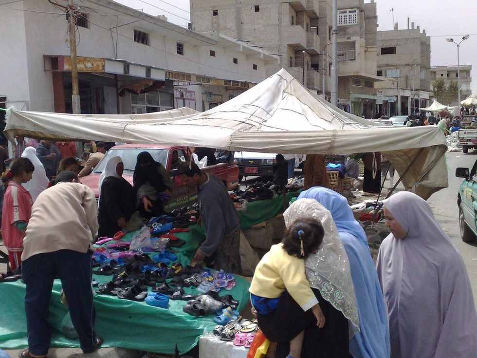 photo of people browsing stalls at a market in Sheikh Zuwayed, North Sinai