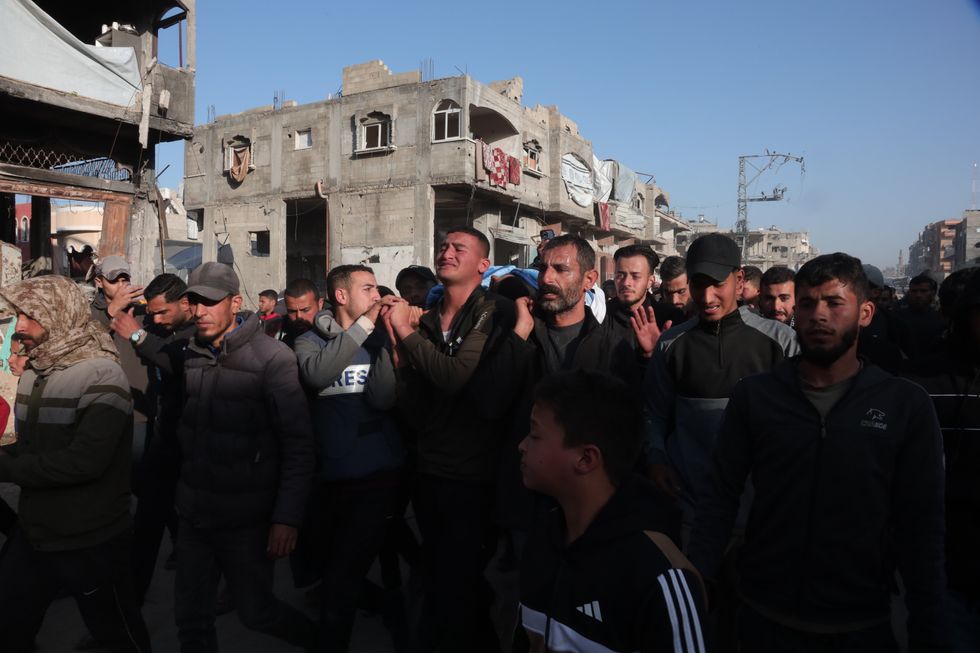 Photo of people carrying the body of Palestinian journalist Hossam Shabat during his funeral in Jabalia refugee camp, northern Gaza, on March 24.