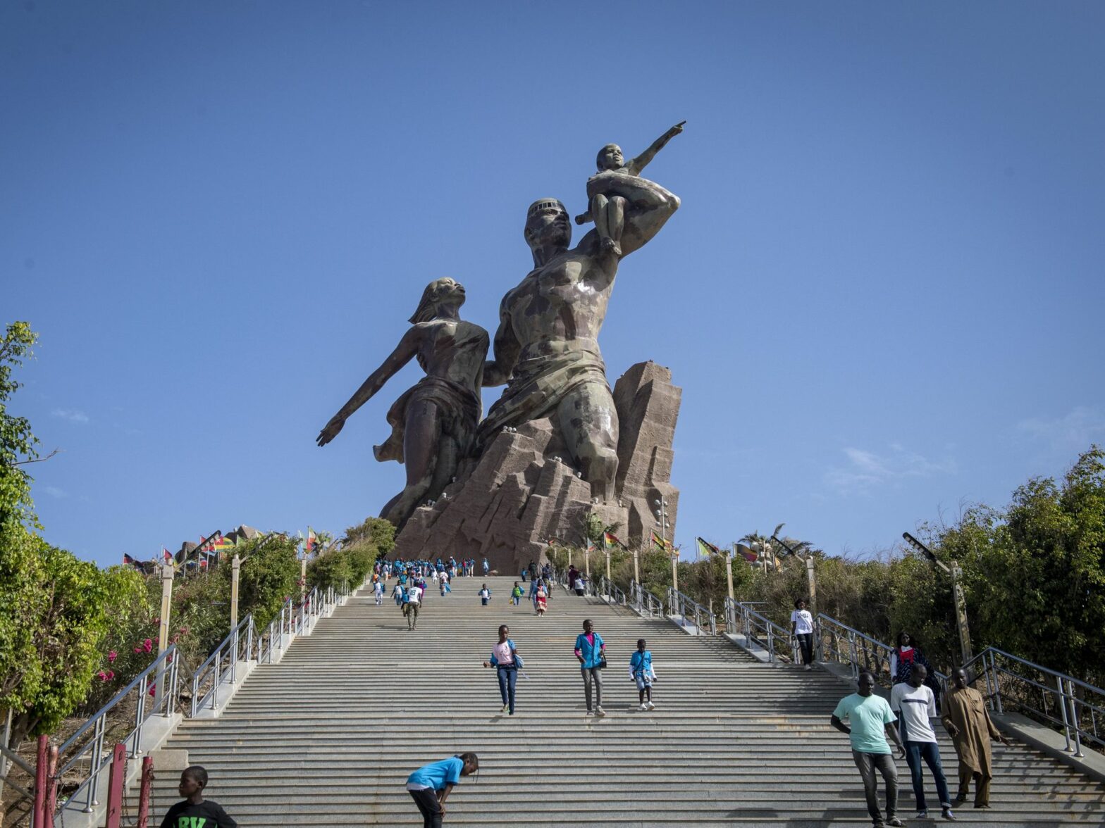 Photo of people climbing down the stairs that lead to the African Renaissance monument in Dakar, Senegal