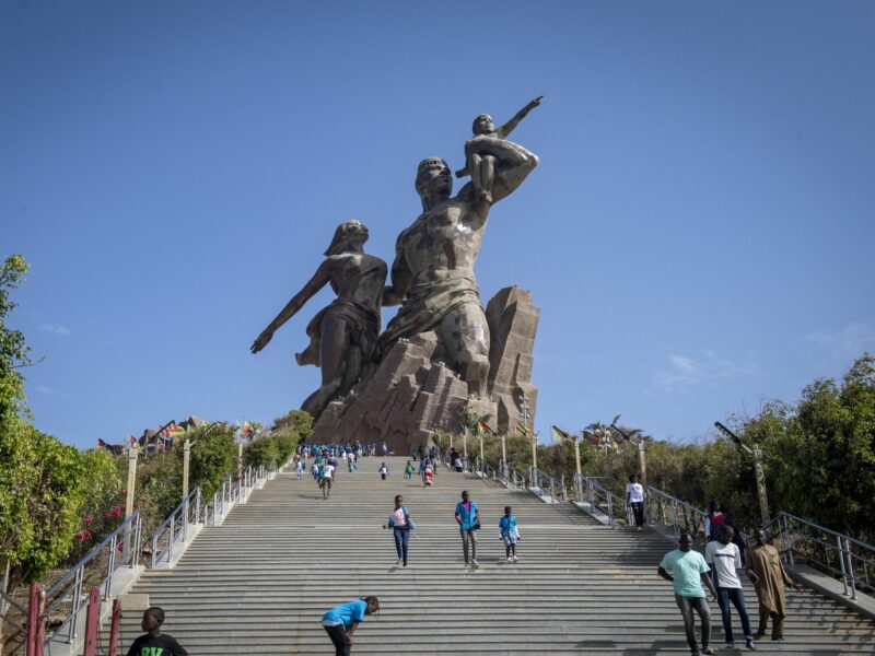 Photo of people climbing down the stairs that lead to the African Renaissance monument in Dakar, Senegal