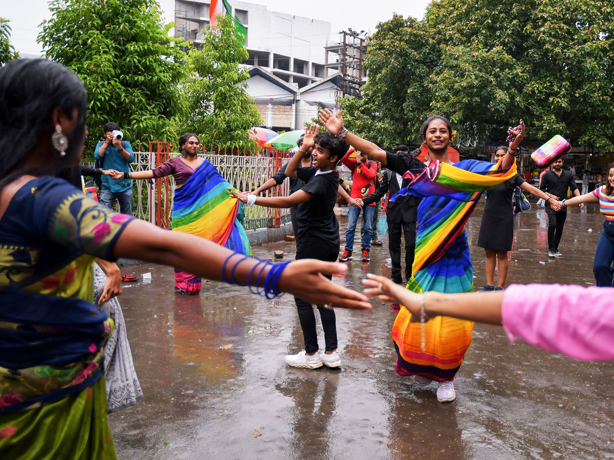 Photo of people dancing while dressed in rainbow-colored clothes at the 2023 Kolkata Pride