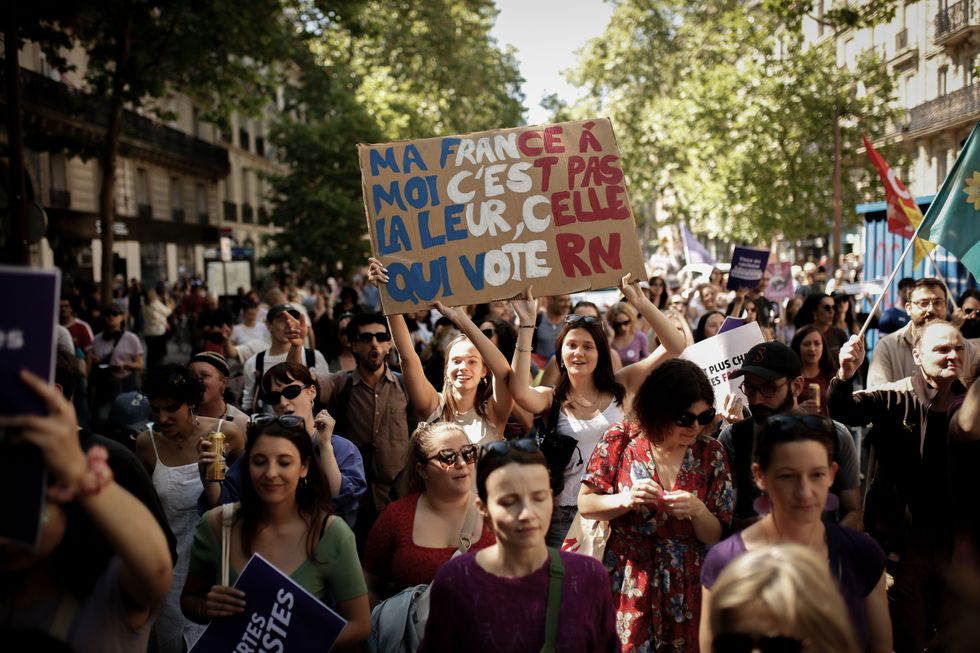 photo of people demonstrating and holding up signs