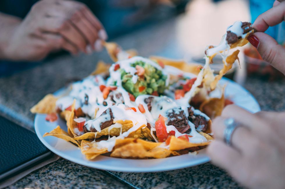 photo of people eating nachos