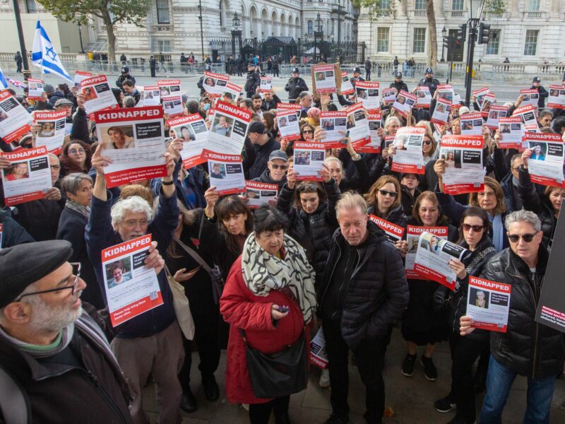 Photo of people holding pictures of hostages held by Hamas during a march in London