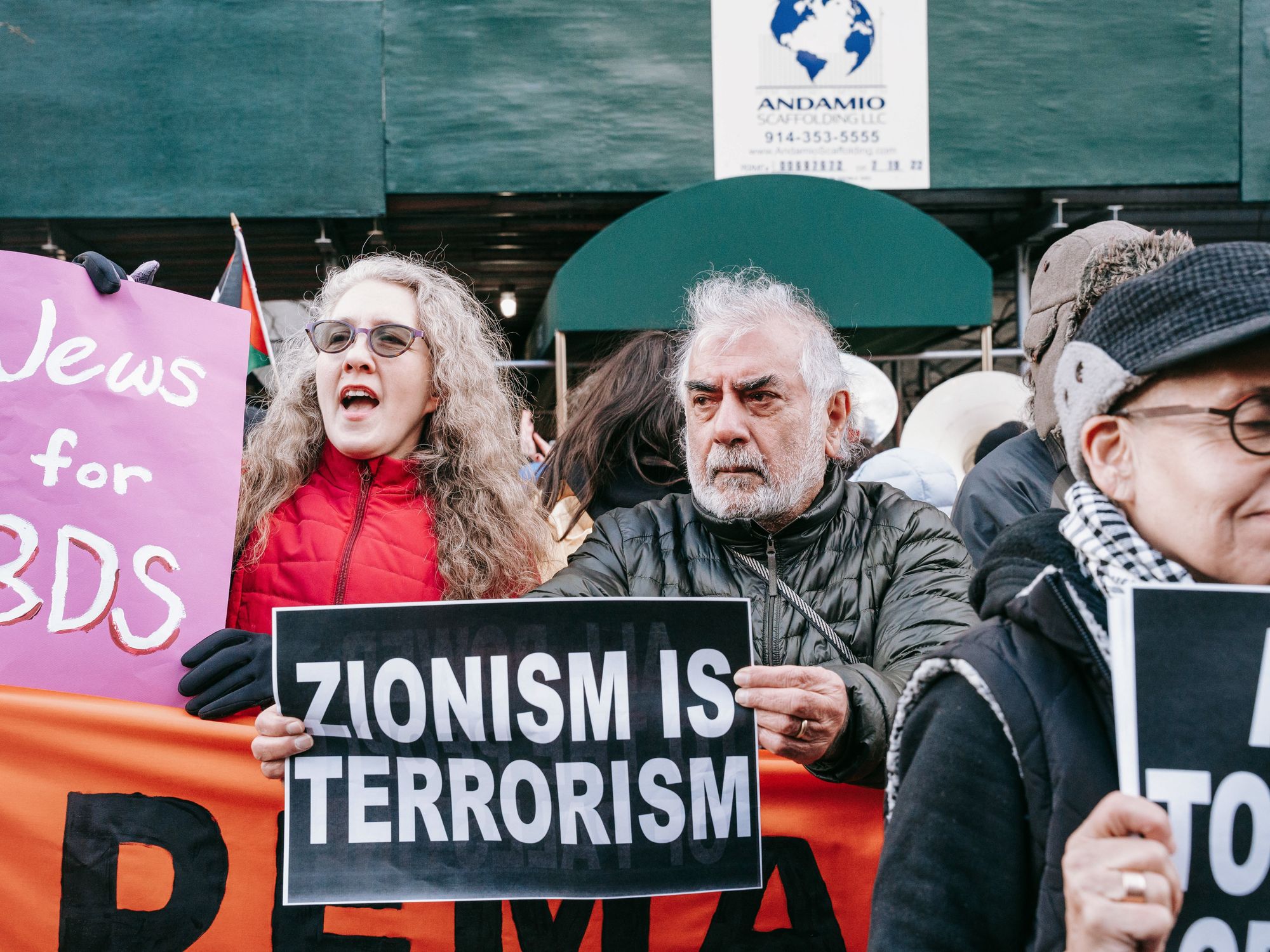 photo of people holding up anti-israel signs: zionism is terrorism