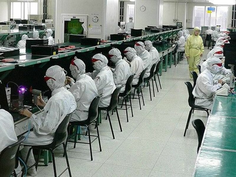 photo of people in white suits working in foxconn factory in China