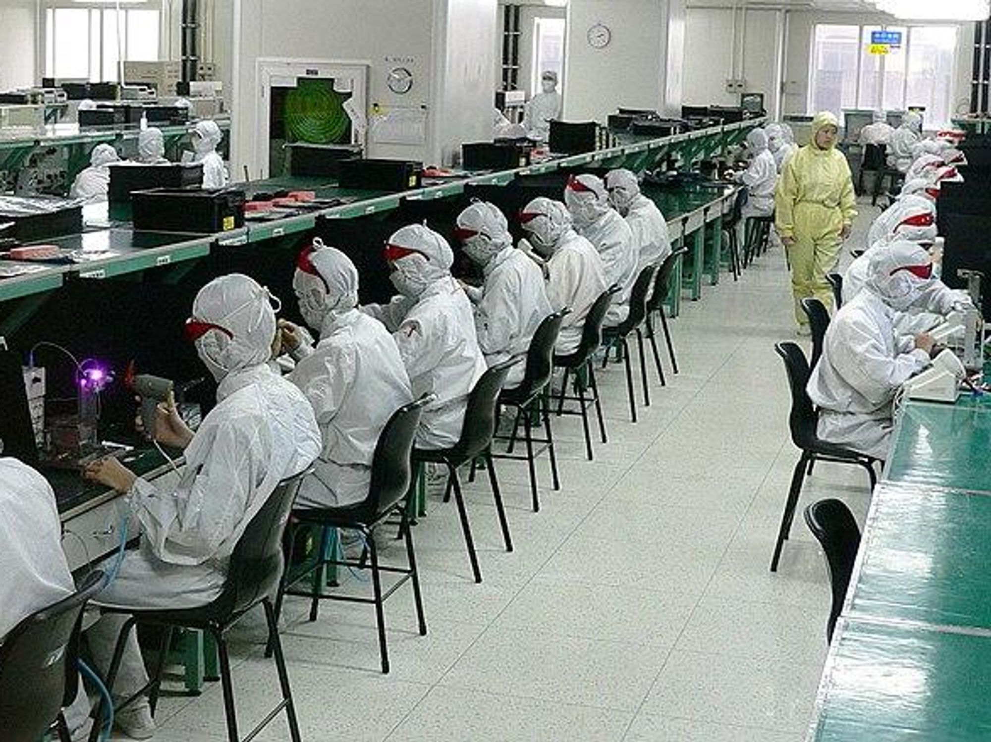 photo of people in white suits working in foxconn factory in China