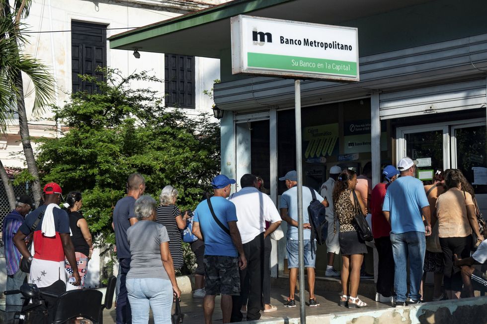 Photo of people lining up at the bank in Cuba, Havana