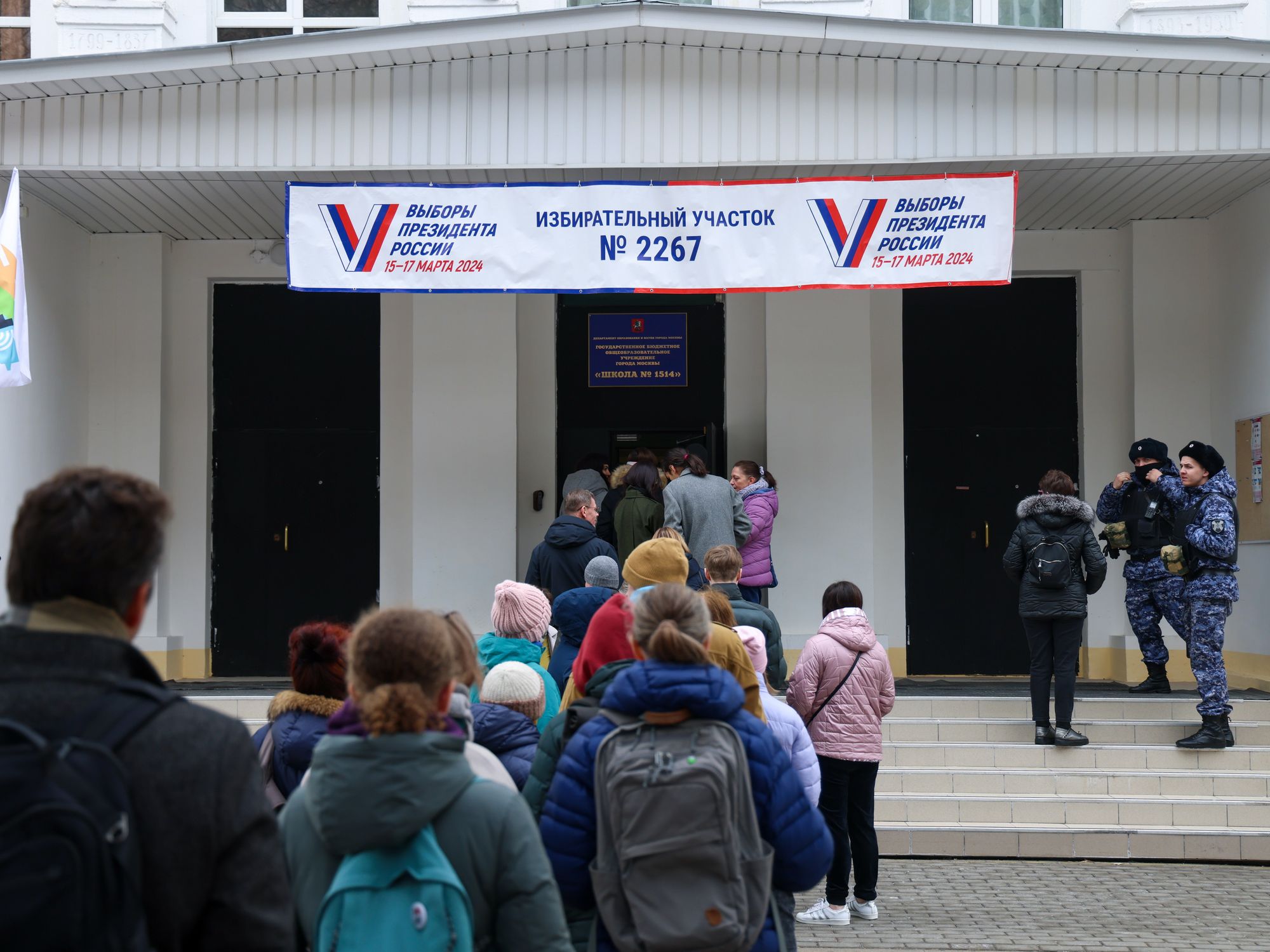 photo of people lining up to enter a polling place