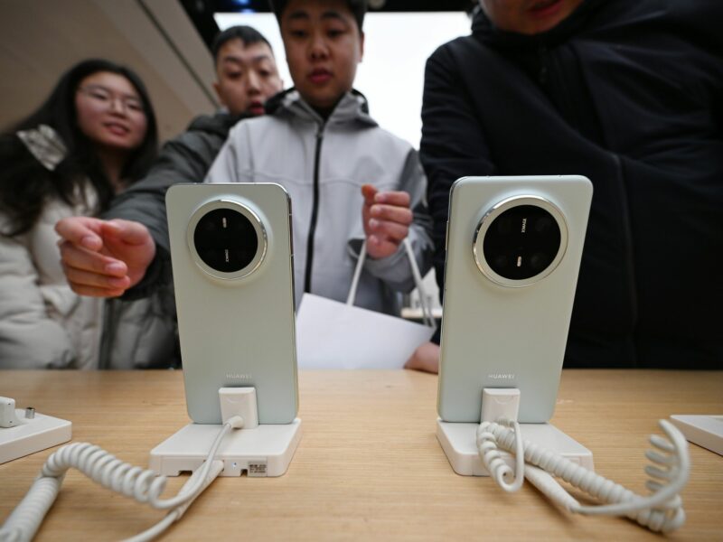 photo of people looking at 2 phones