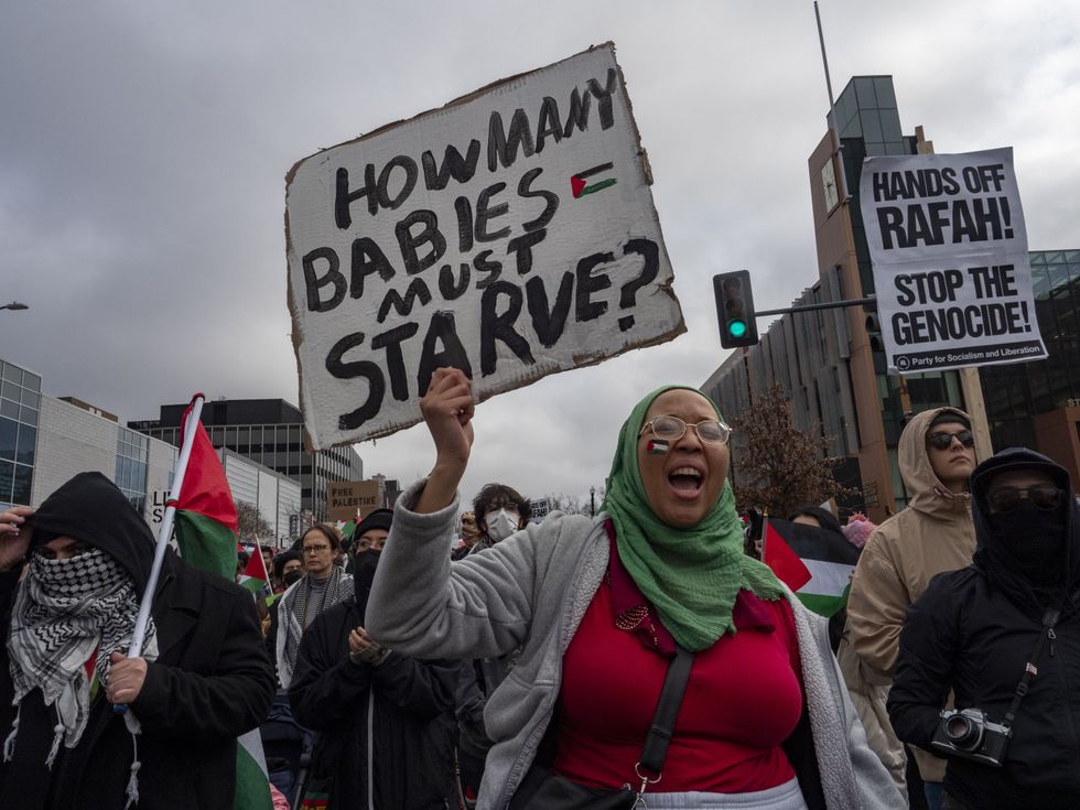 photo of people marching and holding signs