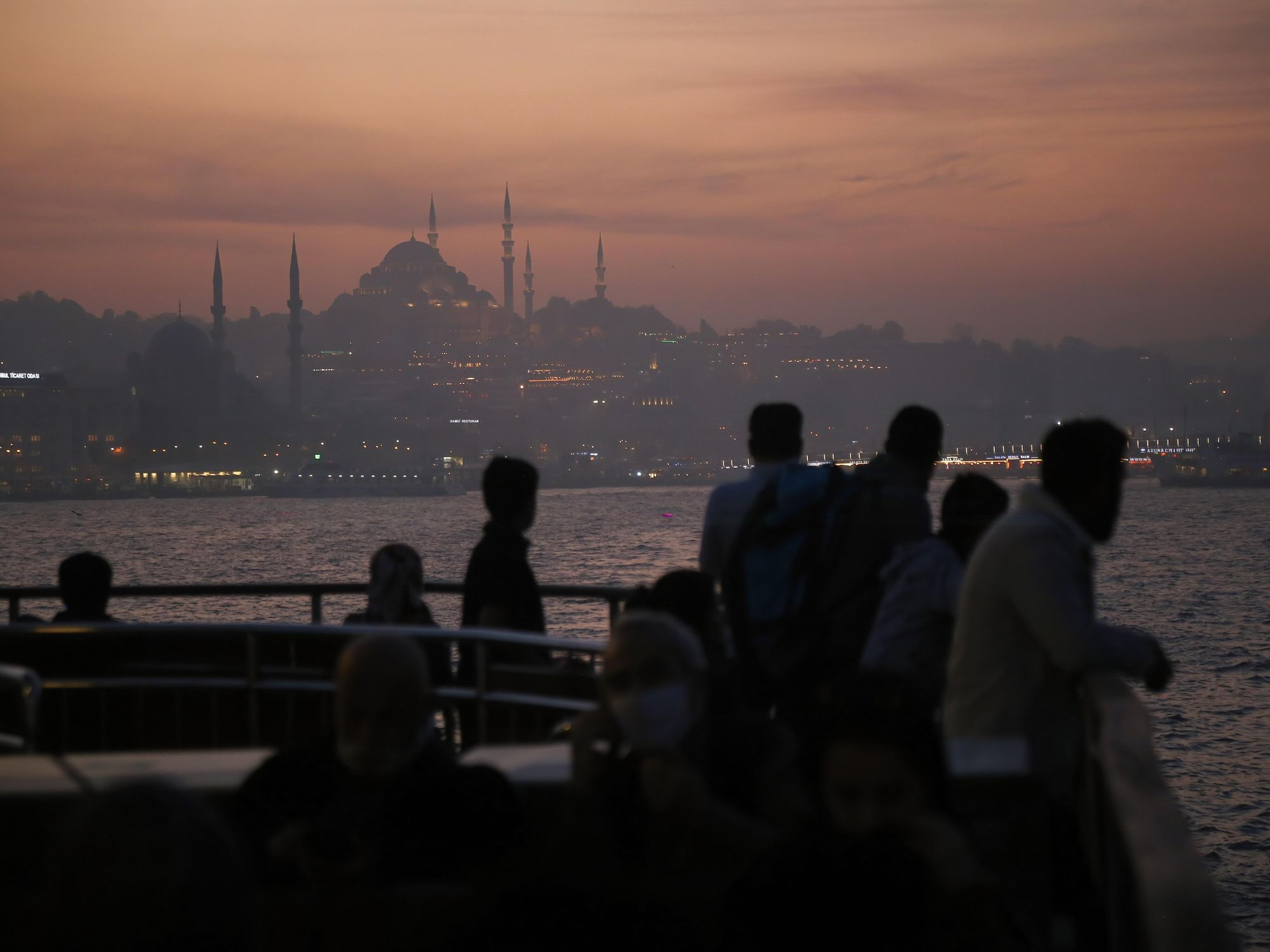 Photo of people on a passenger ferry on the Bosphorus, with Istanbul in the background