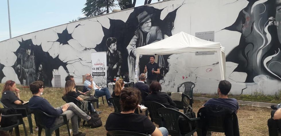 Photo of people participating in a drug-awareness meeting organized by ItaNPUD